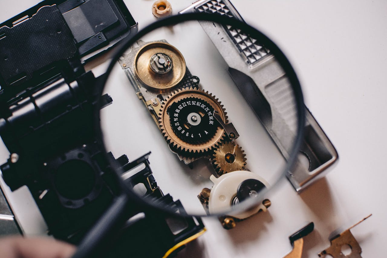 Intricate gears of a camera mechanism magnified, showcasing mechanical precision.